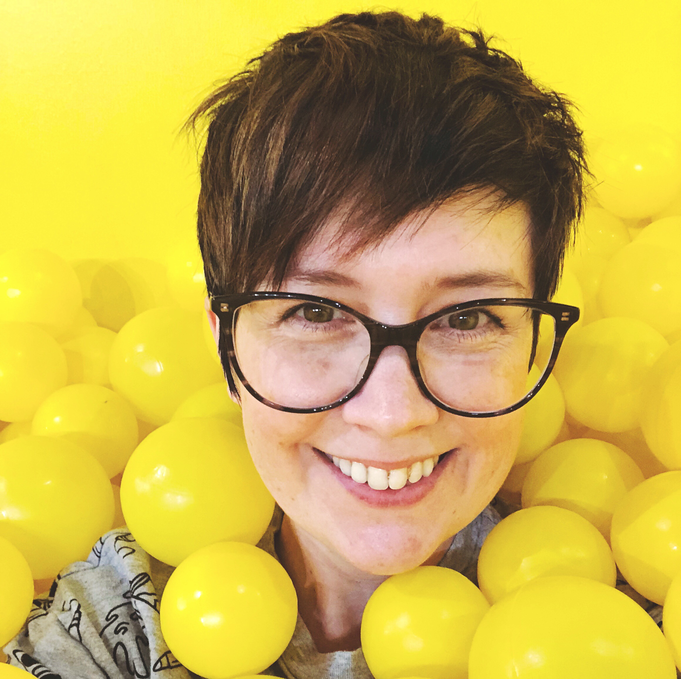 Carrie in a yellow ball pit